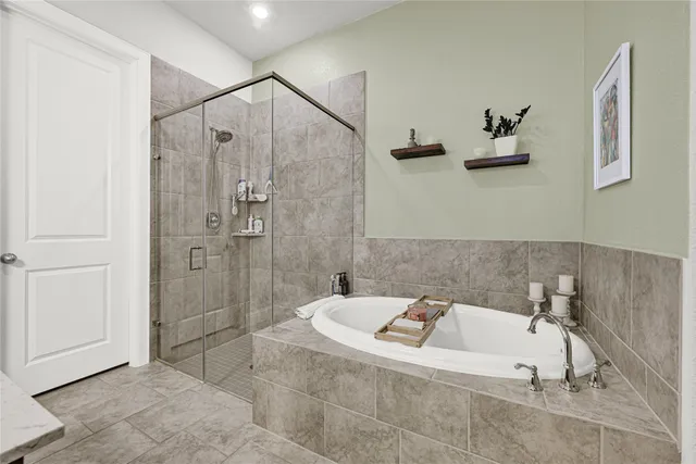a bathroom with a bathtub and shower