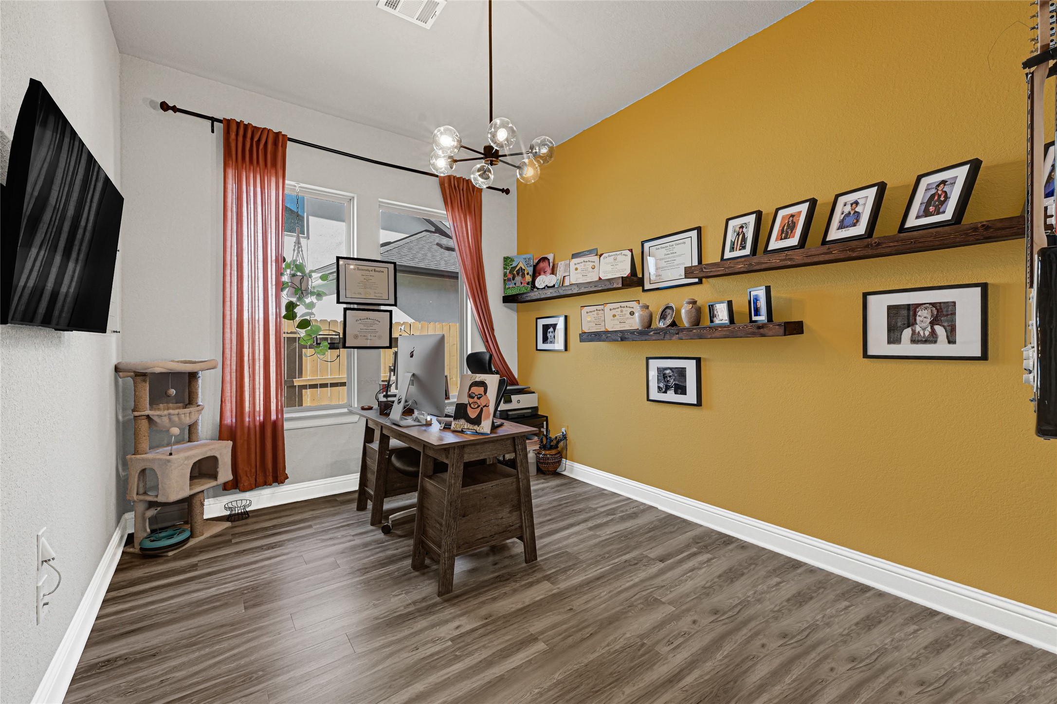 27533 Vivace Drive Spring, TX 77386 - Photo 14 of 26 a view of a dining room with furniture a chandelier and wooden floor