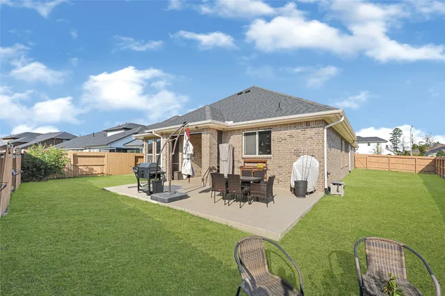a front view of a house with patio yard fire pit and outdoor seating