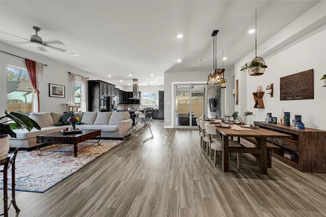 a living room with furniture a rug and a flat screen tv