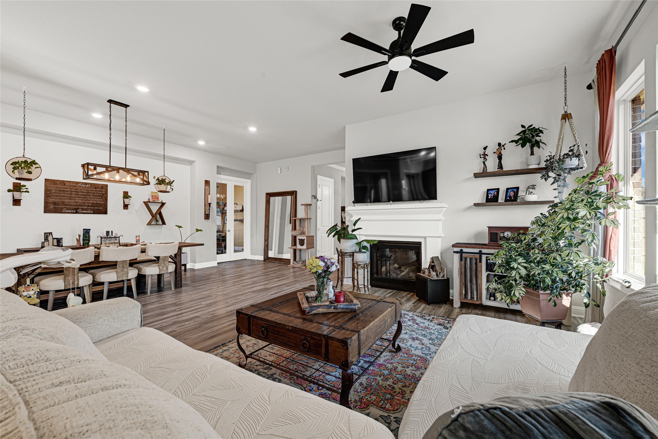 27533 Vivace Drive Spring, TX 77386 - Photo 4 of 26 a living room with furniture a fireplace and a flat screen tv