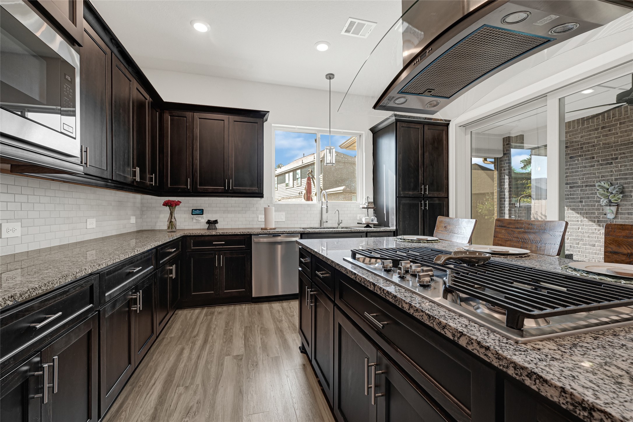 27533 Vivace Drive Spring, TX 77386 - Photo 7 of 26 a kitchen with stainless steel appliances granite countertop a stove and a sink