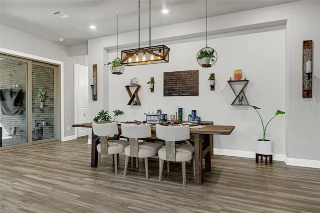 a view of a dining room with furniture wooden floor and chandelier