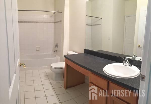 356 Samuel Circle Parlin, NJ 08859 - Photo 6 of 14 a bathroom with a sink a toilet and shower
