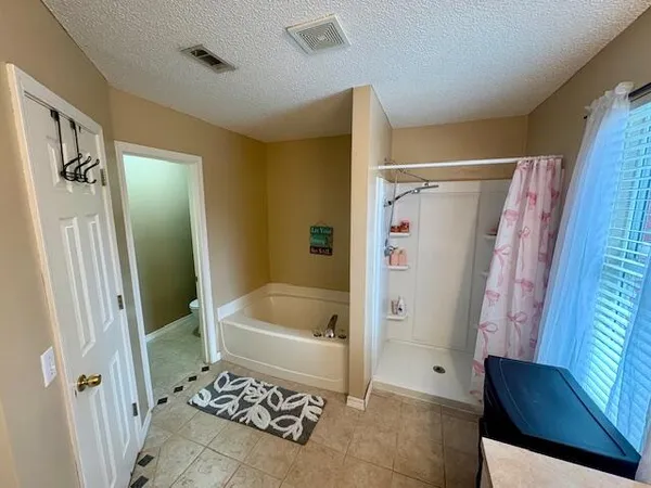 a bathroom with a bathtub and a shower
