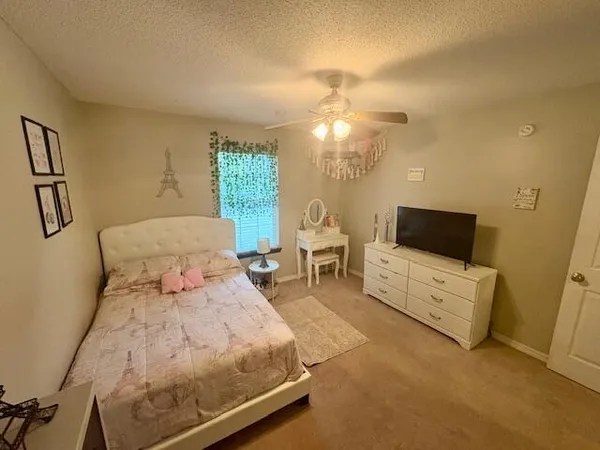 a bedroom with furniture and a flat screen tv