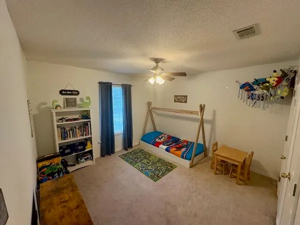a bed room with a bed and a television