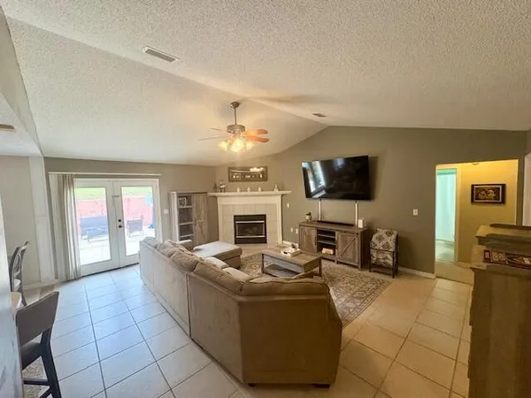 a living room with fireplace furniture and a flat screen tv