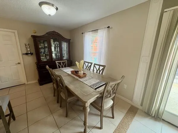 a view of a dining room with furniture and window