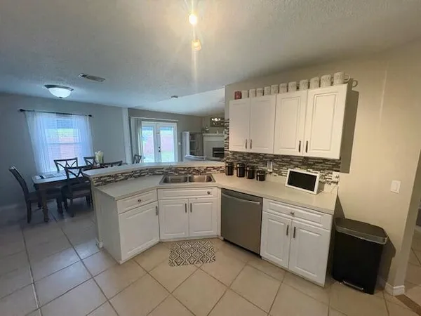 a kitchen with cabinets appliances and a window