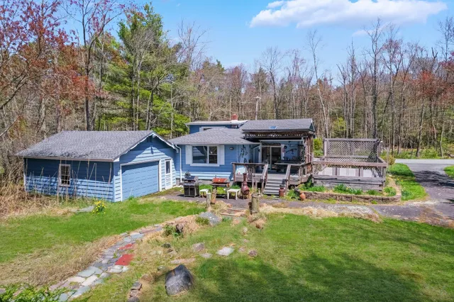 a view of a house with sitting area and garden