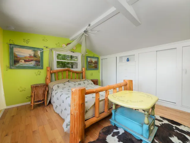 a bedroom with 2 bed table and chair