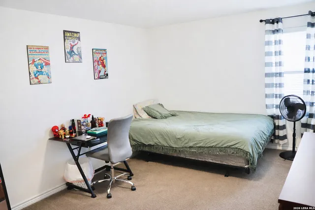 a bedroom with a bed and a chair in it