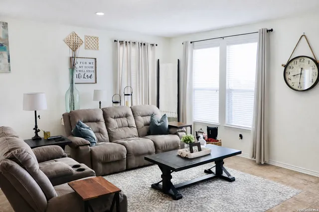 a living room with furniture a large window and a table