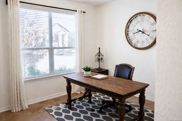 a view of a dining room with furniture and a window