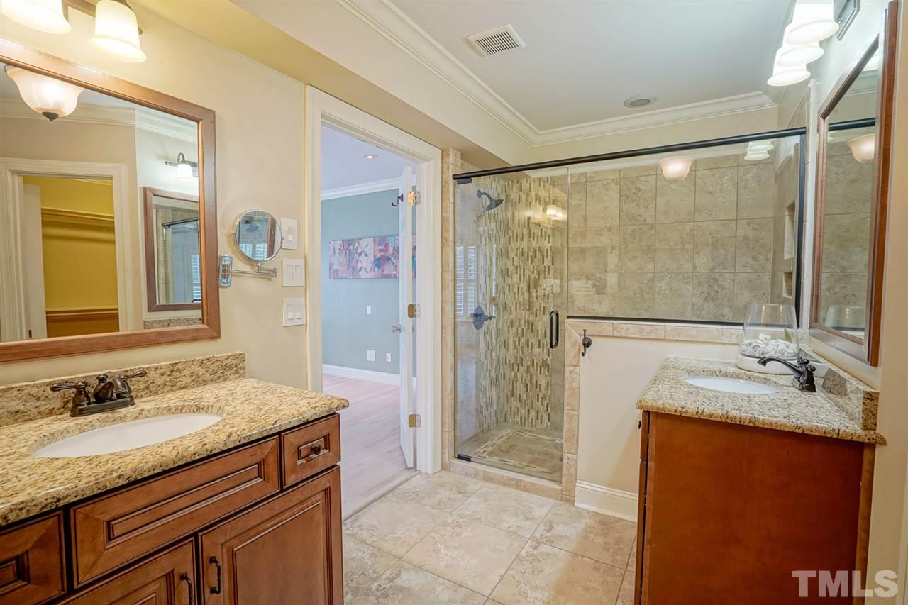 2606 Mayview Road Raleigh, NC 27607 - Photo 14 of 26 a bathroom with a granite countertop sink a mirror and a shower