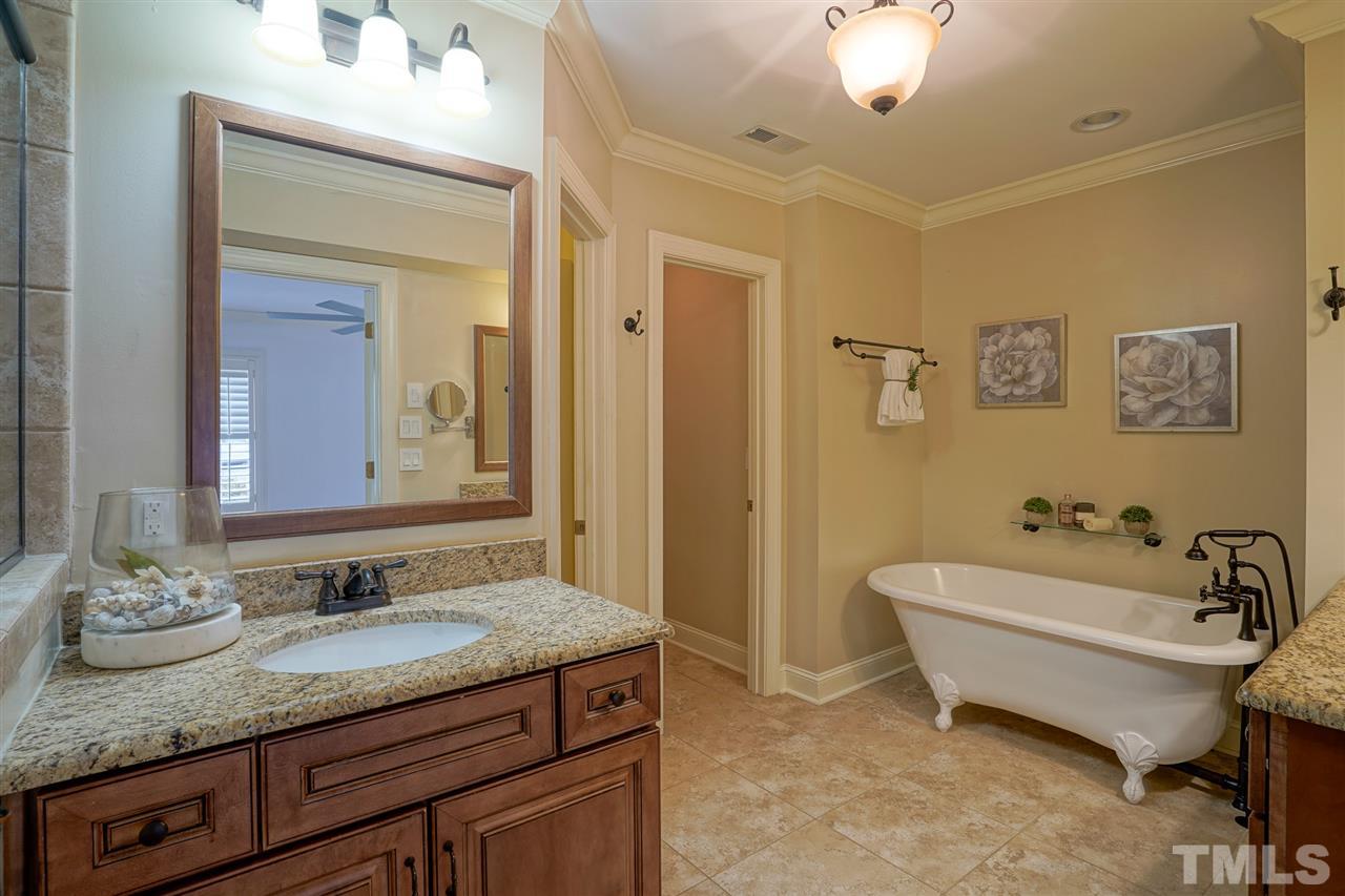 2606 Mayview Road Raleigh, NC 27607 - Photo 15 of 26 a spacious bathroom with a granite countertop sink and a mirror