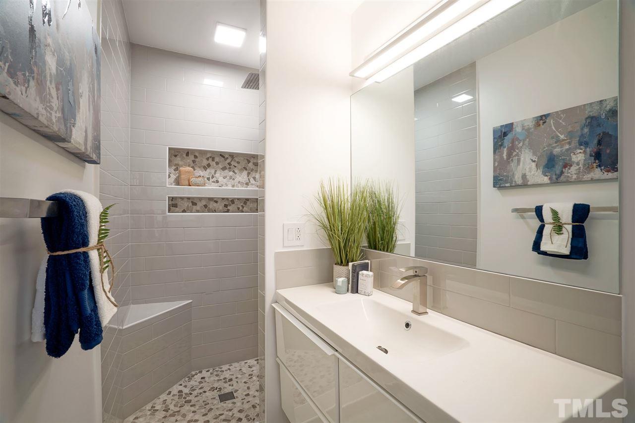 2606 Mayview Road Raleigh, NC 27607 - Photo 18 of 26 a bathroom with a sink and a mirror