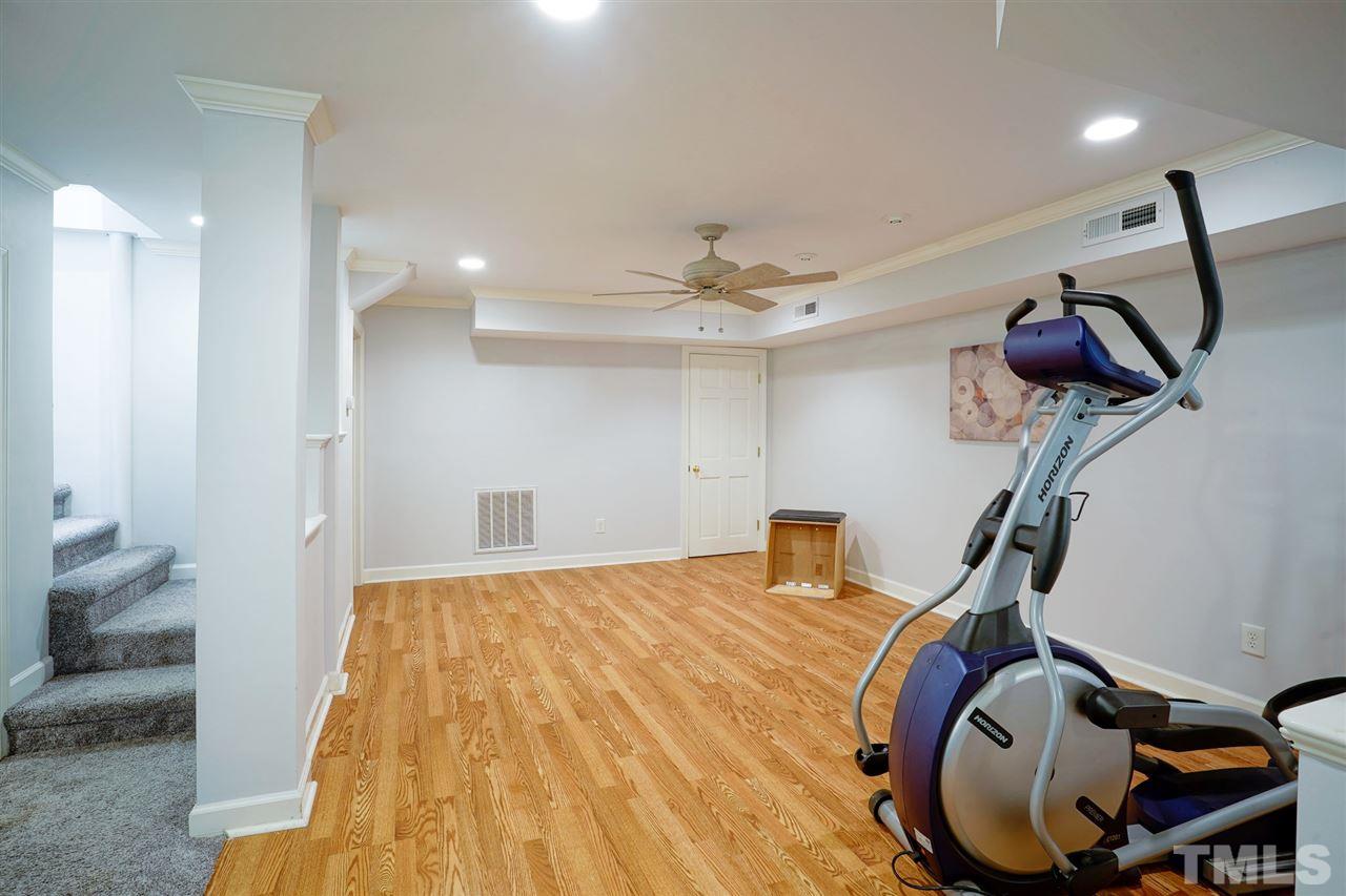 2606 Mayview Road Raleigh, NC 27607 - Photo 19 of 26 a bedroom with a bed and cabinets