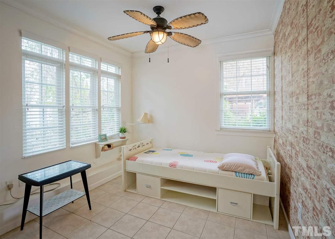2606 Mayview Road Raleigh, NC 27607 - Photo 22 of 26 a bedroom with a bed and a window