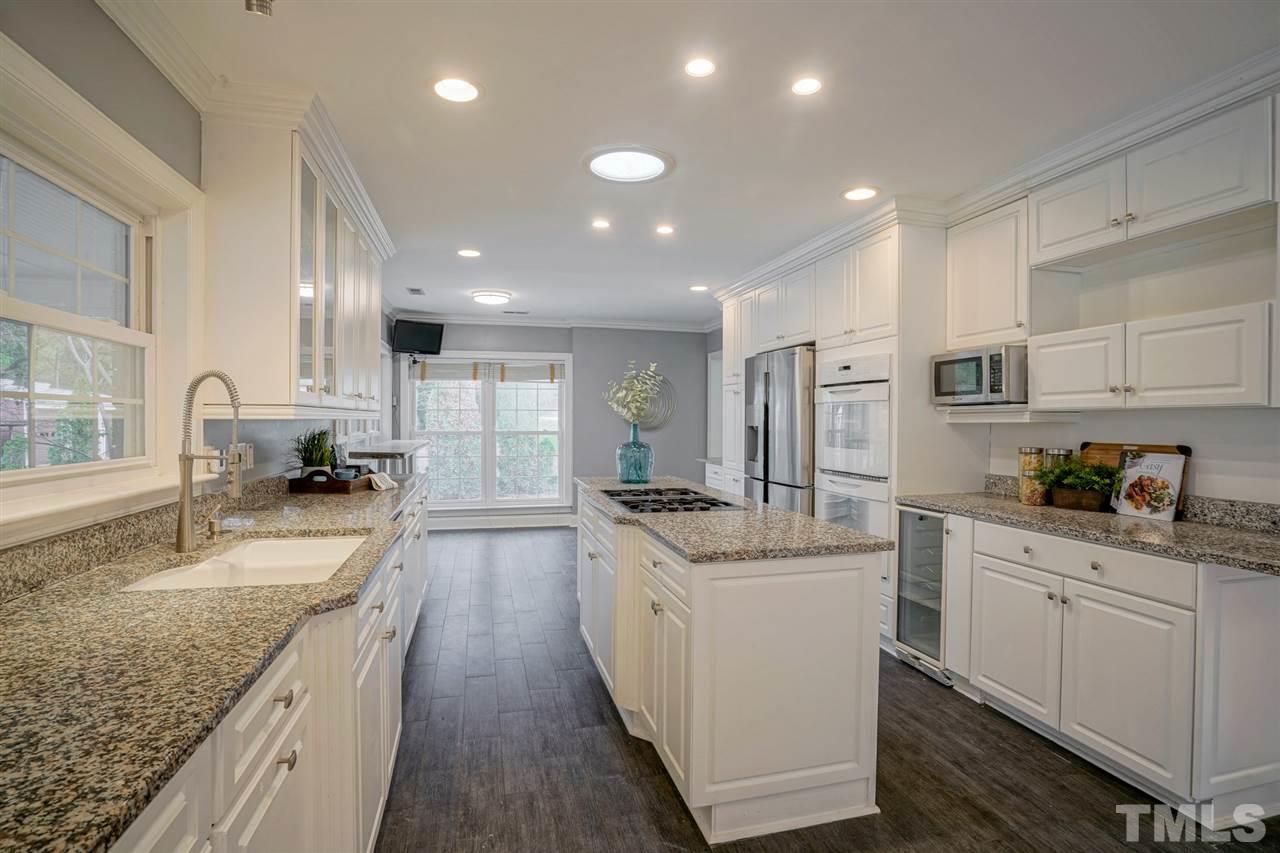 2606 Mayview Road Raleigh, NC 27607 - Photo 8 of 26 a large kitchen with stainless steel appliances lots of counter space and wooden floor