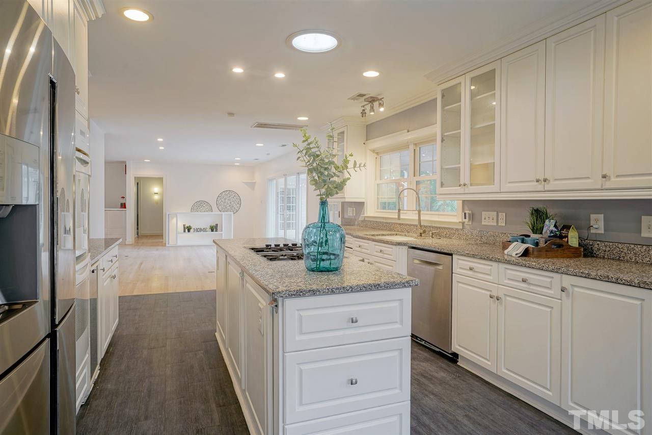 2606 Mayview Road Raleigh, NC 27607 - Photo 10 of 26 a kitchen with granite countertop white cabinets and white appliances