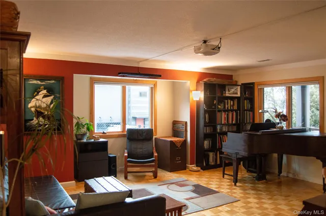 a work room with furniture and a floor to ceiling window