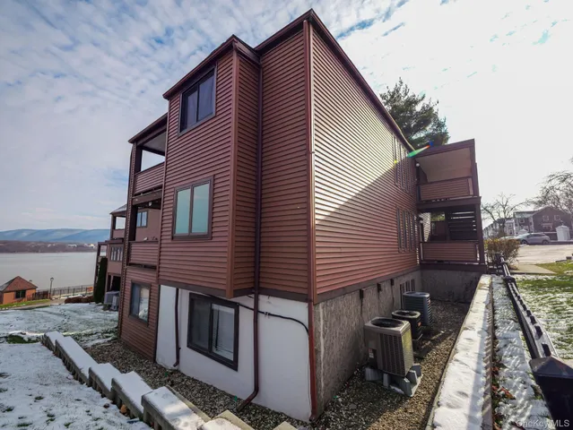 a wooden bench sitting in front of a house