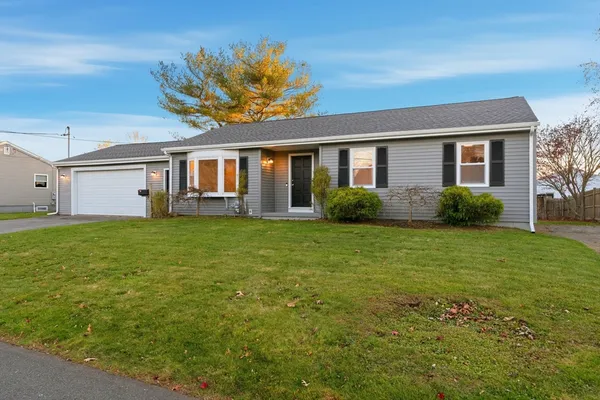 a front view of house with yard and green space