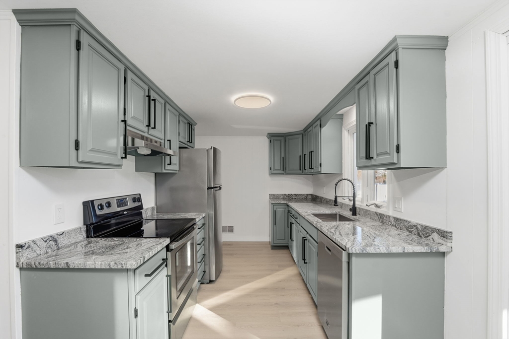 95 Samson Avenue Somerset, MA 02726 - Photo 11 of 36 a kitchen with stainless steel appliances granite countertop a sink stove and cabinets