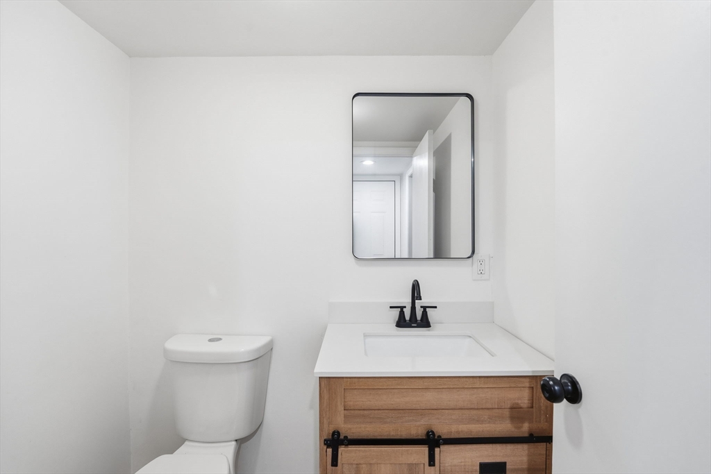 95 Samson Avenue Somerset, MA 02726 - Photo 16 of 36 a bathroom with a toilet sink and mirror