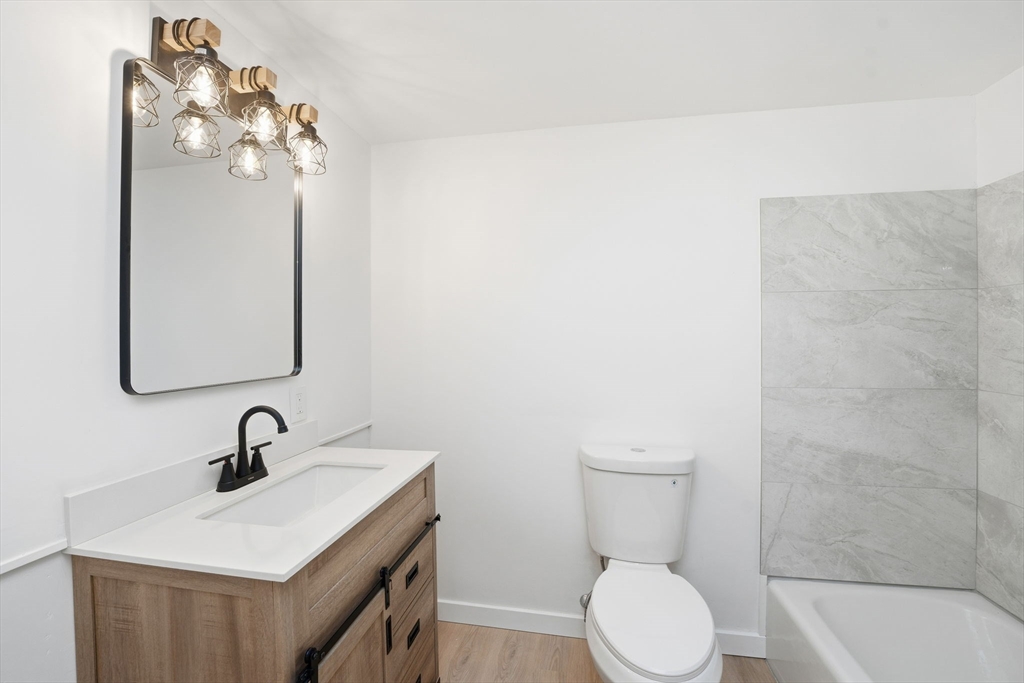 95 Samson Avenue Somerset, MA 02726 - Photo 17 of 36 a bathroom with a sink a toilet and a mirror