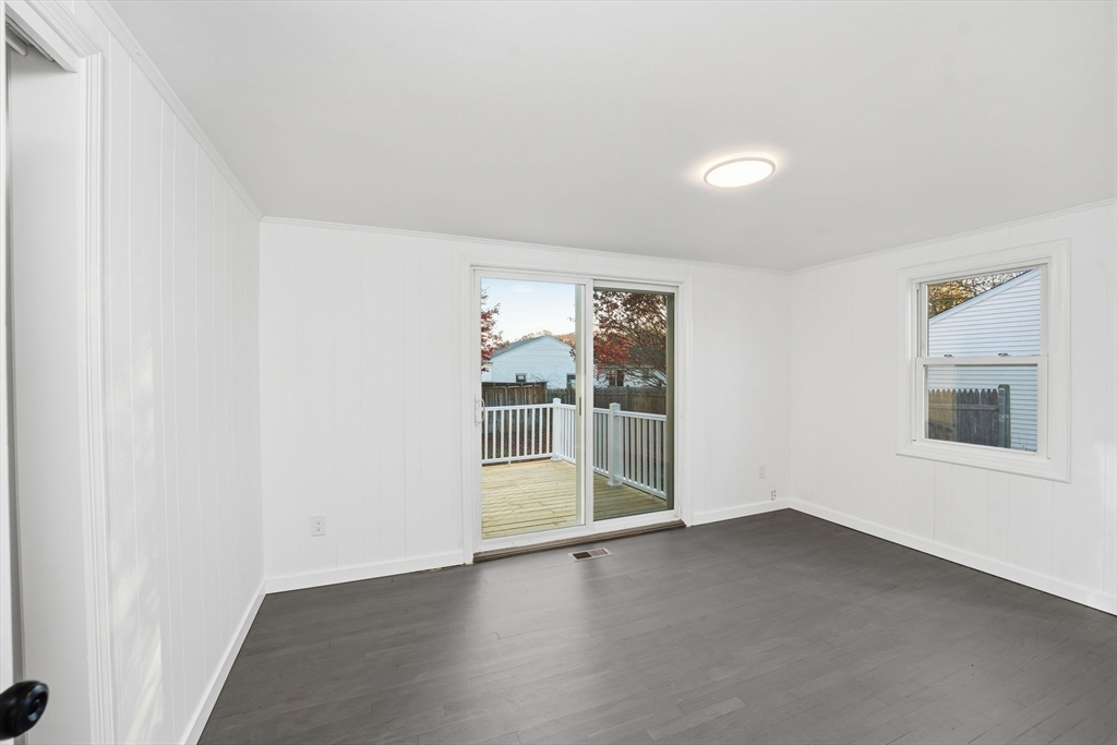 95 Samson Avenue Somerset, MA 02726 - Photo 22 of 36 an empty room with wooden floor and windows
