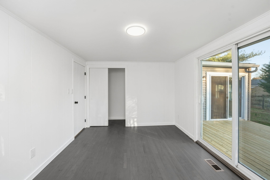 95 Samson Avenue Somerset, MA 02726 - Photo 24 of 36 an empty room with wooden floor and windows
