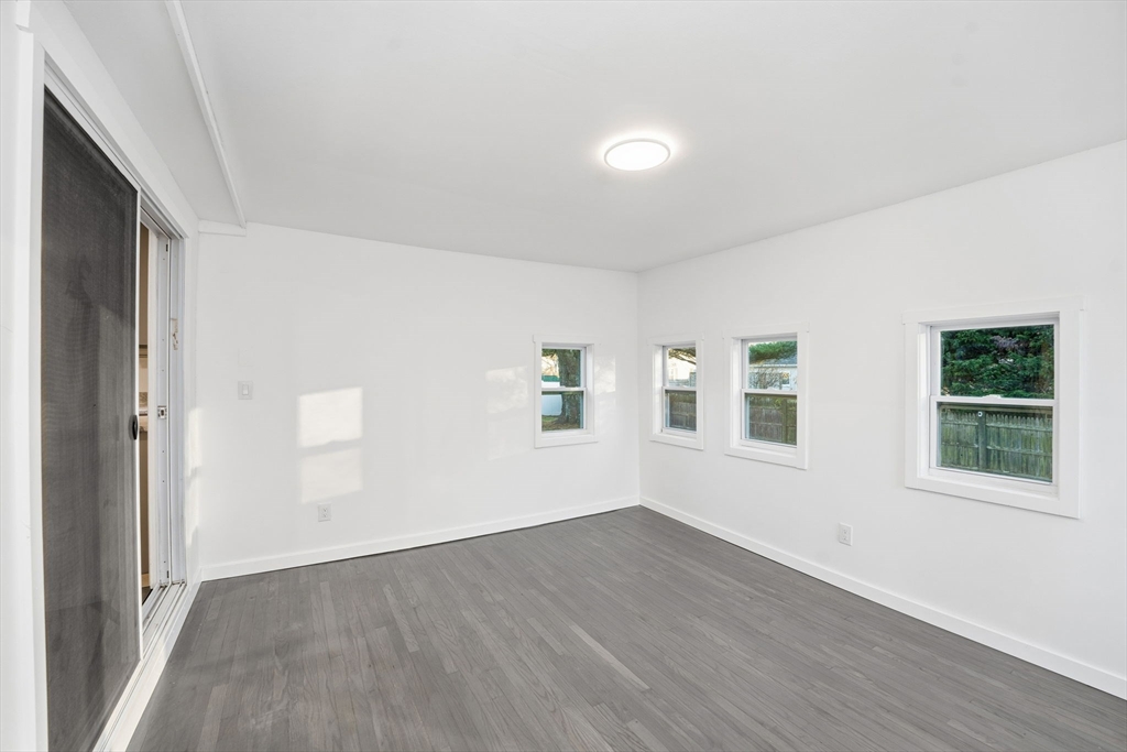 95 Samson Avenue Somerset, MA 02726 - Photo 27 of 36 an empty room with wooden floor and windows