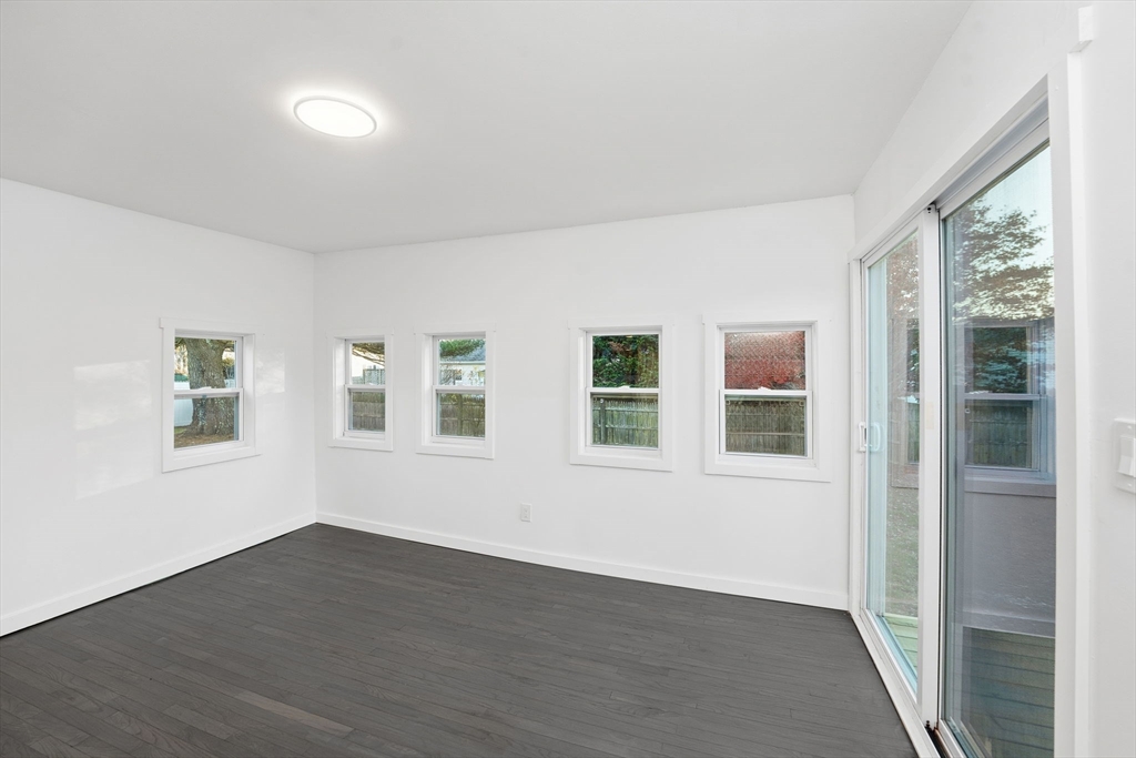 95 Samson Avenue Somerset, MA 02726 - Photo 28 of 36 a view of an empty room with a window and wooden floor