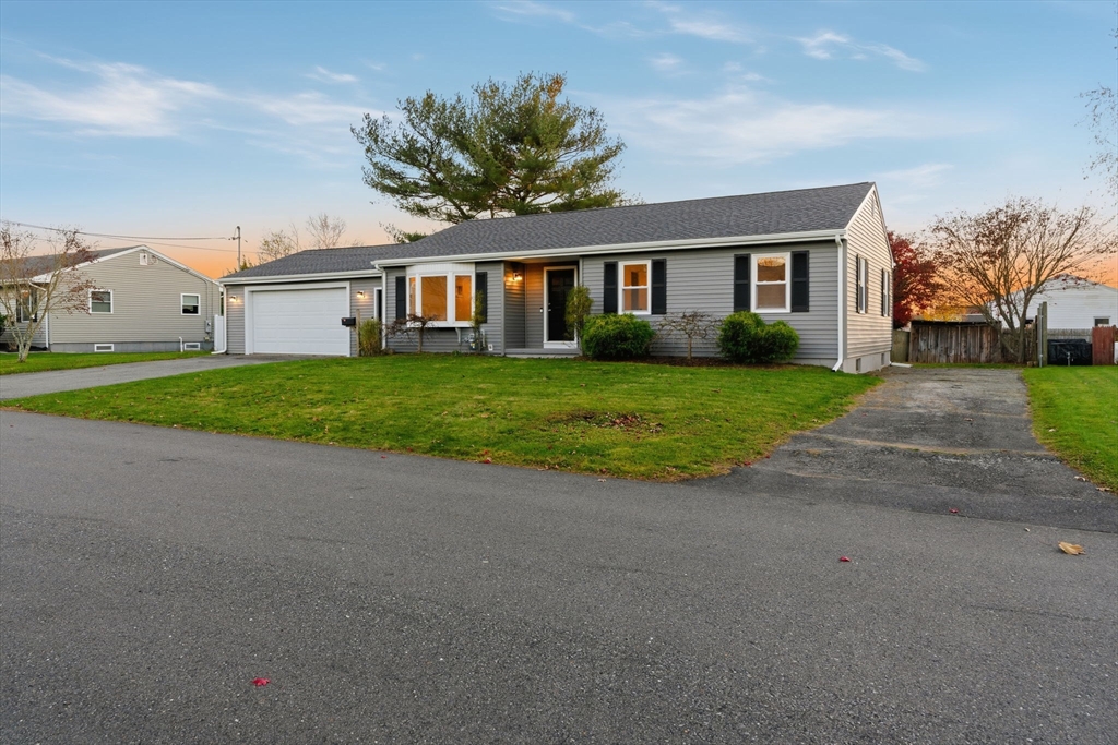 95 Samson Avenue Somerset, MA 02726 - Photo 7 of 36 a front view of a house with a yard and garage