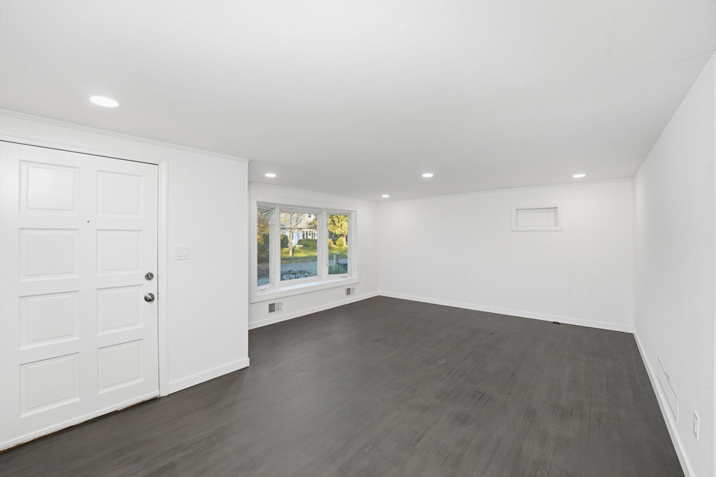 95 Samson Avenue Somerset, MA 02726 - Photo 8 of 36 an empty room with wooden floor and windows