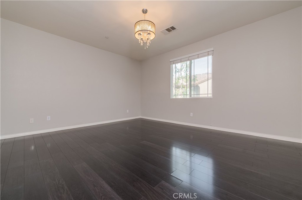 6014 Eucalyptus Avenue Chino, CA 91710 - Photo 12 of 16 an empty room with wooden floor and windows