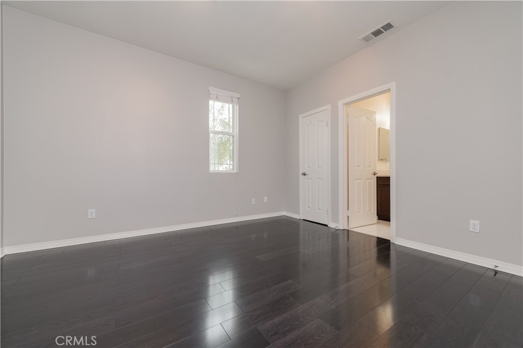 6014 Eucalyptus Avenue Chino, CA 91710 - Photo 9 of 16 an empty room with wooden floor and windows