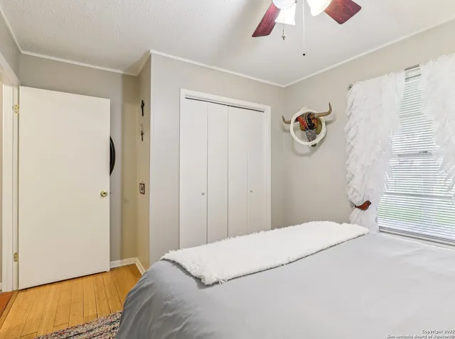 a bedroom with a bed and a painting on the wall