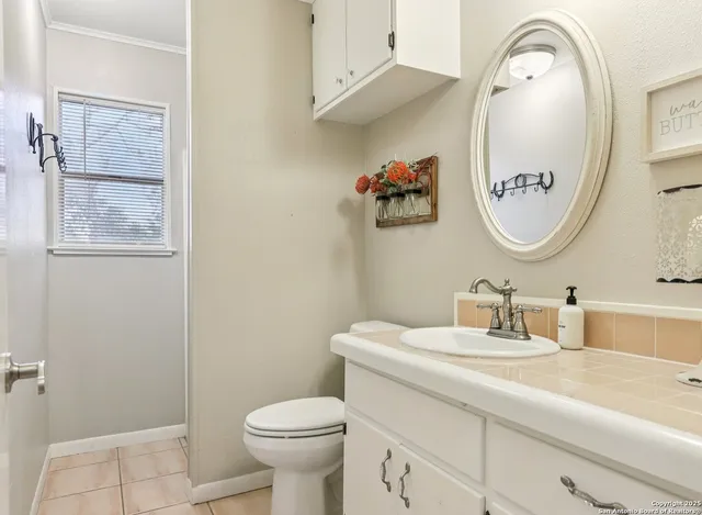 a bathroom with a toilet a sink and mirror