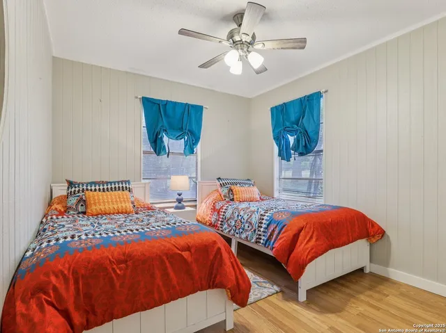 a bedroom with two beds and a chandelier