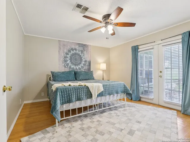 a bedroom with a large bed and a chandelier