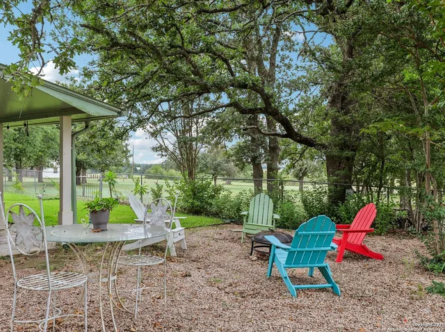 an outdoor sitting area with couch and umbrella