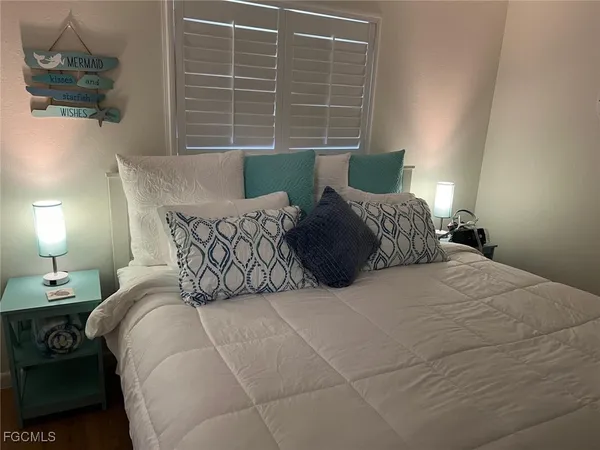 a bedroom with a bed and window