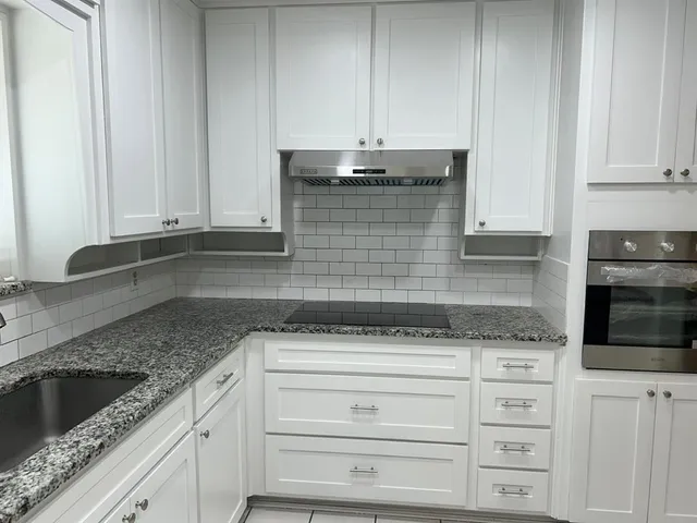 a kitchen with a stove a sink and a refrigerator