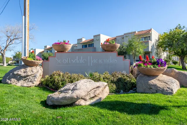 a view of a backyard with plants and flowers
