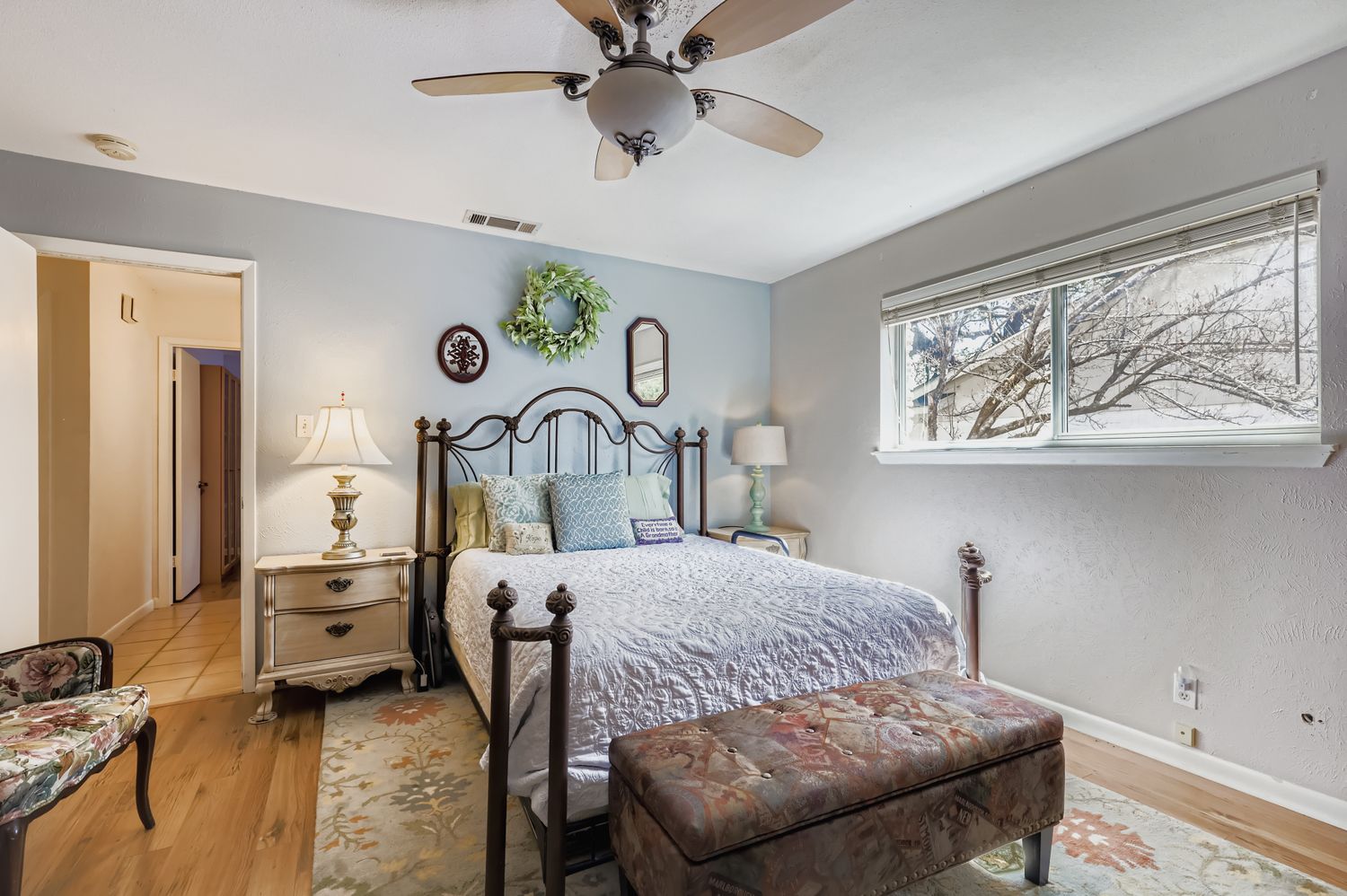 11718 Running Fox Trail Austin, TX 78759 - Photo 17 of 30 a bedroom with a bed and a chandelier