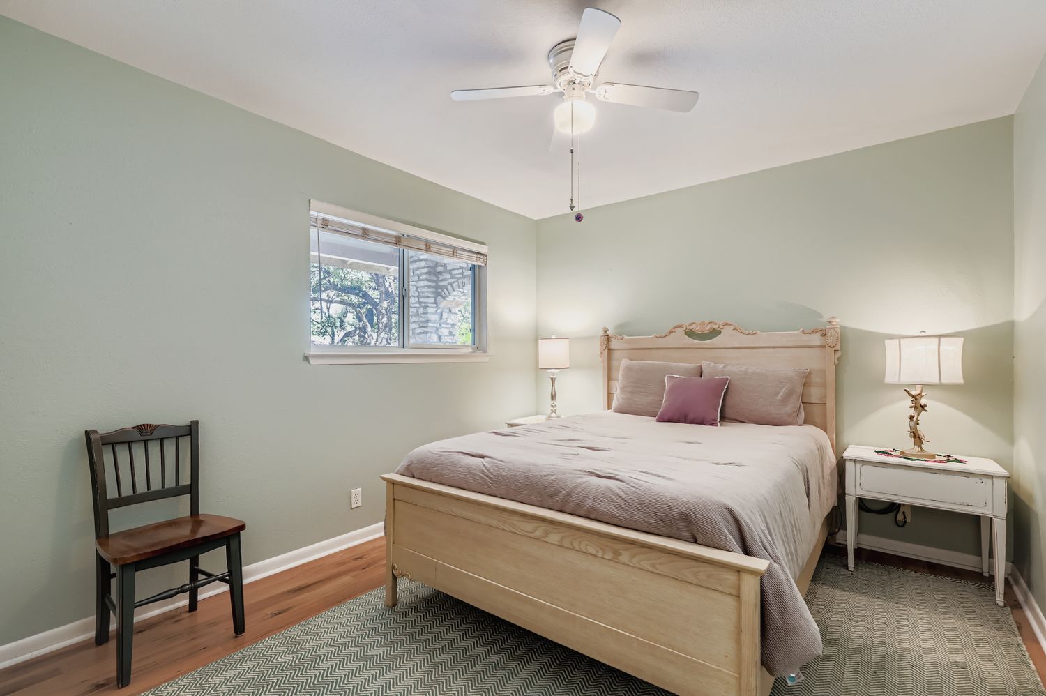 11718 Running Fox Trail Austin, TX 78759 - Photo 21 of 30 a bedroom with a bed and a chandelier